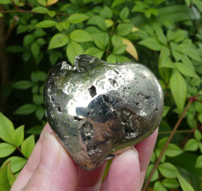 Pyrite Heart 4.9cm by 4.2cm drop from centre. 2.4cm thickness approx *Please note photo’s are close up and cropped so can result in the item being magnified so please check measurements. The natural sunlight may enhance the beautiful natural colours. Photos are of the actual crystal you are buying. Metaphysical Properties Pyrite is a very protective stone, shielding the user from negative energy of all kinds. Pyrite blocks energy leaks and mends auric tears. Carry Pyrite in your pocket to protect you from both environmental pollution and physical danger. Pyrite also promotes good physical health and emotional well-being.